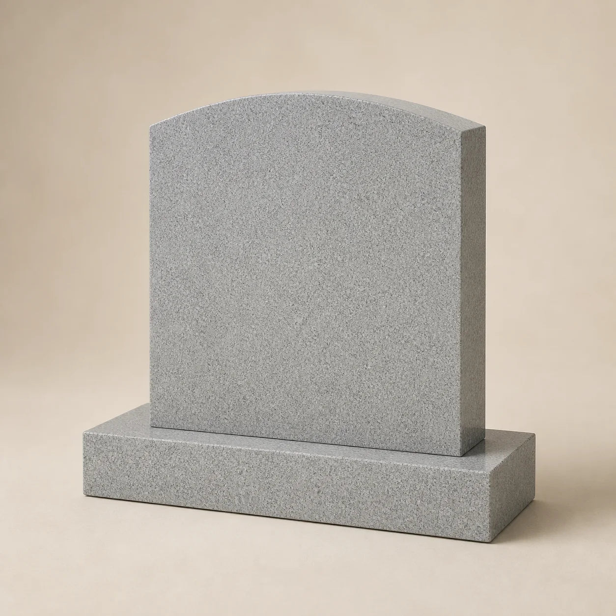 Monument funerar neinscripționat din granit gri, cu placă arcuită și soclu